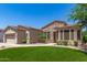 Well-maintained single-story home featuring manicured desert landscaping and stone accents on the facade at 4626 E Blue Spruce Ln, Gilbert, AZ 85298