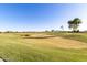 Expansive golf course view featuring lush green fairways, sand traps, and mountain views in the distance at 4626 E Blue Spruce Ln, Gilbert, AZ 85298