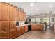 Large kitchen with wooden cabinetry, a breakfast bar, and tiled flooring at 4626 E Blue Spruce Ln, Gilbert, AZ 85298