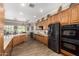 Spacious kitchen featuring wooden cabinets, stainless steel appliances, and tiled floors at 4626 E Blue Spruce Ln, Gilbert, AZ 85298