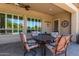 Outdoor patio seating area with metal table and cushioned chairs and view of backyard at 4626 E Blue Spruce Ln, Gilbert, AZ 85298