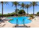 Resort-style pool with palm trees, waterfall feature, and plenty of seating for relaxation at 4626 E Blue Spruce Ln, Gilbert, AZ 85298
