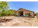A private backyard with covered patio with stucco house that is ready for landscaping at 4826 W Ardmore Rd, Laveen, AZ 85339