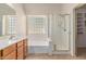 Bright bathroom with a glass enclosed shower and soaking tub at 4826 W Ardmore Rd, Laveen, AZ 85339