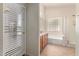 Bathroom featuring double sinks, tub, shower, and natural light at 4826 W Ardmore Rd, Laveen, AZ 85339