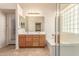 Bright bathroom with a double sink vanity, bathtub, and separate shower at 4826 W Ardmore Rd, Laveen, AZ 85339