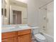 A full bathroom featuring a tub with shower, toilet, and wood vanity with white sink and mirror at 4826 W Ardmore Rd, Laveen, AZ 85339