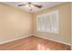 A serene bedroom with laminate floors, a ceiling fan and a shuttered window for natural light control at 4826 W Ardmore Rd, Laveen, AZ 85339