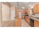 Spacious kitchen featuring wood cabinets, stainless steel appliances, tile flooring, and island at 4826 W Ardmore Rd, Laveen, AZ 85339
