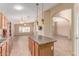 Open-concept kitchen and living room, featuring a large kitchen island at 4826 W Ardmore Rd, Laveen, AZ 85339