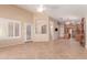 An open-concept living room with tile floors and neutral walls leading to kitchen and other rooms at 4826 W Ardmore Rd, Laveen, AZ 85339