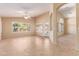 Open living room with neutral paint, tile flooring, ceiling fan, and plantation shutters at 4826 W Ardmore Rd, Laveen, AZ 85339