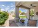 Inviting covered back patio with ceiling fan and outdoor seating overlooking the manicured backyard at 5014 E Kirkland Rd, Phoenix, AZ 85054