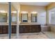 A luxurious main bathroom featuring double sinks, granite countertops, and a glass-enclosed shower at 5014 E Kirkland Rd, Phoenix, AZ 85054