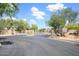 Elegant gated community entrance with mature trees, landscaping, and American flag, offering security at 5014 E Kirkland Rd, Phoenix, AZ 85054