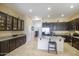 Spacious kitchen featuring dark cabinetry, a central island, and modern stainless steel appliances at 5014 E Kirkland Rd, Phoenix, AZ 85054