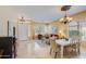 A dining and living room area featuring tile flooring, a chandelier, and bright natural light at 5014 E Kirkland Rd, Phoenix, AZ 85054