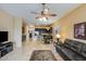 Open-concept living room featuring tile flooring, a ceiling fan, and seamless flow into the dining and kitchen areas at 5014 E Kirkland Rd, Phoenix, AZ 85054