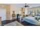 A well-lit main bedroom with hardwood floors, ceiling fan, a writing desk, and large windows at 5014 E Kirkland Rd, Phoenix, AZ 85054