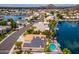 Stunning aerial view of a waterfront home featuring a pool, solar panels, and beautiful landscaping on a sunny day at 5510 W Arrowhead Lakes Dr, Glendale, AZ 85308