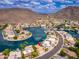Gorgeous aerial shot of a waterfront community with luxurious homes, boat docks, tranquil canals, and mountain views at 5510 W Arrowhead Lakes Dr, Glendale, AZ 85308