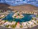 Expansive aerial shot of an upscale neighborhood with waterfront homes, serene canals, and stunning mountain views at 5510 W Arrowhead Lakes Dr, Glendale, AZ 85308