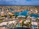 Panoramic aerial view of an expansive waterfront community featuring luxurious homes, serene canals, and mountain views at 5510 W Arrowhead Lakes Dr, Glendale, AZ 85308