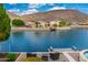 This backyard features a patio with a fire pit overlooking the lake and mountains at 5510 W Arrowhead Lakes Dr, Glendale, AZ 85308