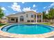 Beautiful backyard featuring a pristine pool surrounded by well-manicured landscaping and a spacious patio at 5510 W Arrowhead Lakes Dr, Glendale, AZ 85308