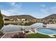 Backyard with pool overlooking the lake and mountains of a waterfront property at 5510 W Arrowhead Lakes Dr, Glendale, AZ 85308