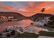 Backyard pool at sunset overlooking the lake and mountains of a waterfront property at 5510 W Arrowhead Lakes Dr, Glendale, AZ 85308