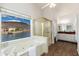 Luxurious bathroom with a soaking tub and view to the lake at 5510 W Arrowhead Lakes Dr, Glendale, AZ 85308