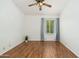 Empty bedroom with wood laminate flooring, white walls and a window at 5510 W Arrowhead Lakes Dr, Glendale, AZ 85308