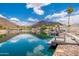 Picturesque waterfront view showcasing a private dock with seating, perfect for enjoying the serene lake at 5510 W Arrowhead Lakes Dr, Glendale, AZ 85308