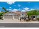 Charming home featuring a three-car garage, desert landscaping, and a pristine stucco exterior under a sunny sky at 5510 W Arrowhead Lakes Dr, Glendale, AZ 85308