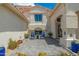 Cozy front porch with blue chairs and desert landscaping leading to the front door of the home at 5510 W Arrowhead Lakes Dr, Glendale, AZ 85308