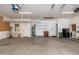 Large garage with a sink, storage cabinets, and ample open space for parking and projects at 5510 W Arrowhead Lakes Dr, Glendale, AZ 85308