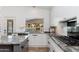 Modern kitchen featuring granite countertops, white cabinets, and a view of the lake at 5510 W Arrowhead Lakes Dr, Glendale, AZ 85308