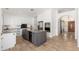 Modern kitchen featuring an island with granite countertops, white cabinets, and stainless steel appliances at 5510 W Arrowhead Lakes Dr, Glendale, AZ 85308