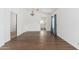 Bright, open-concept living room featuring hardwood floors and an arched entryway to the kitchen at 5510 W Arrowhead Lakes Dr, Glendale, AZ 85308