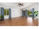 Light-filled room featuring hardwood floors, a fan, and water views at 5510 W Arrowhead Lakes Dr, Glendale, AZ 85308