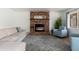 Comfortable living room featuring a brick fireplace and ample seating at 5510 W Arrowhead Lakes Dr, Glendale, AZ 85308