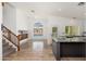 Bright living room with stairs, tile floor, vaulted ceiling and large window overlooking a pool at 5510 W Arrowhead Lakes Dr, Glendale, AZ 85308