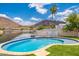 Inviting backyard pool with a beautiful lake view, palm trees, and mountain scenery at 5510 W Arrowhead Lakes Dr, Glendale, AZ 85308