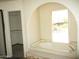 Bathroom featuring a bathtub with an arched window at 5716 E Desert Vista Trl, Cave Creek, AZ 85331