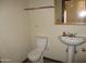 Modest bathroom features a toilet, sink and mirror, ready for renovation at 5716 E Desert Vista Trl, Cave Creek, AZ 85331