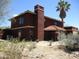 Two-story stucco house with a red-tiled roof and chimney along with desert landscaping at 5716 E Desert Vista Trl, Cave Creek, AZ 85331