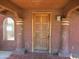 Covered porch showcasing a carved wood front door, tile flooring, and decorative columns at 5716 E Desert Vista Trl, Cave Creek, AZ 85331