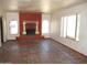 Living room area featuring decorative fireplace, tile flooring, and bright windows at 5716 E Desert Vista Trl, Cave Creek, AZ 85331