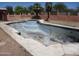 View of the home's exterior featuring a pool with a safety net, concrete edging, and grassy yard at 5716 E Desert Vista Trl, Cave Creek, AZ 85331